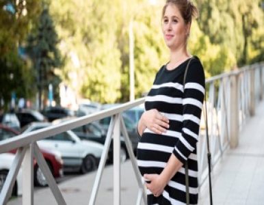 pregnant-woman-holding-her-belly-outdoorsResized